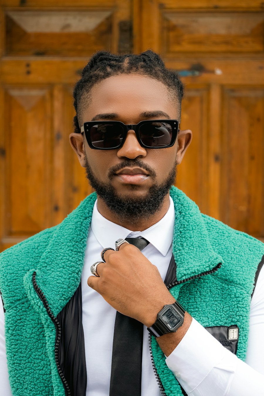 Black male fashion model wearing a textured teal outer layer